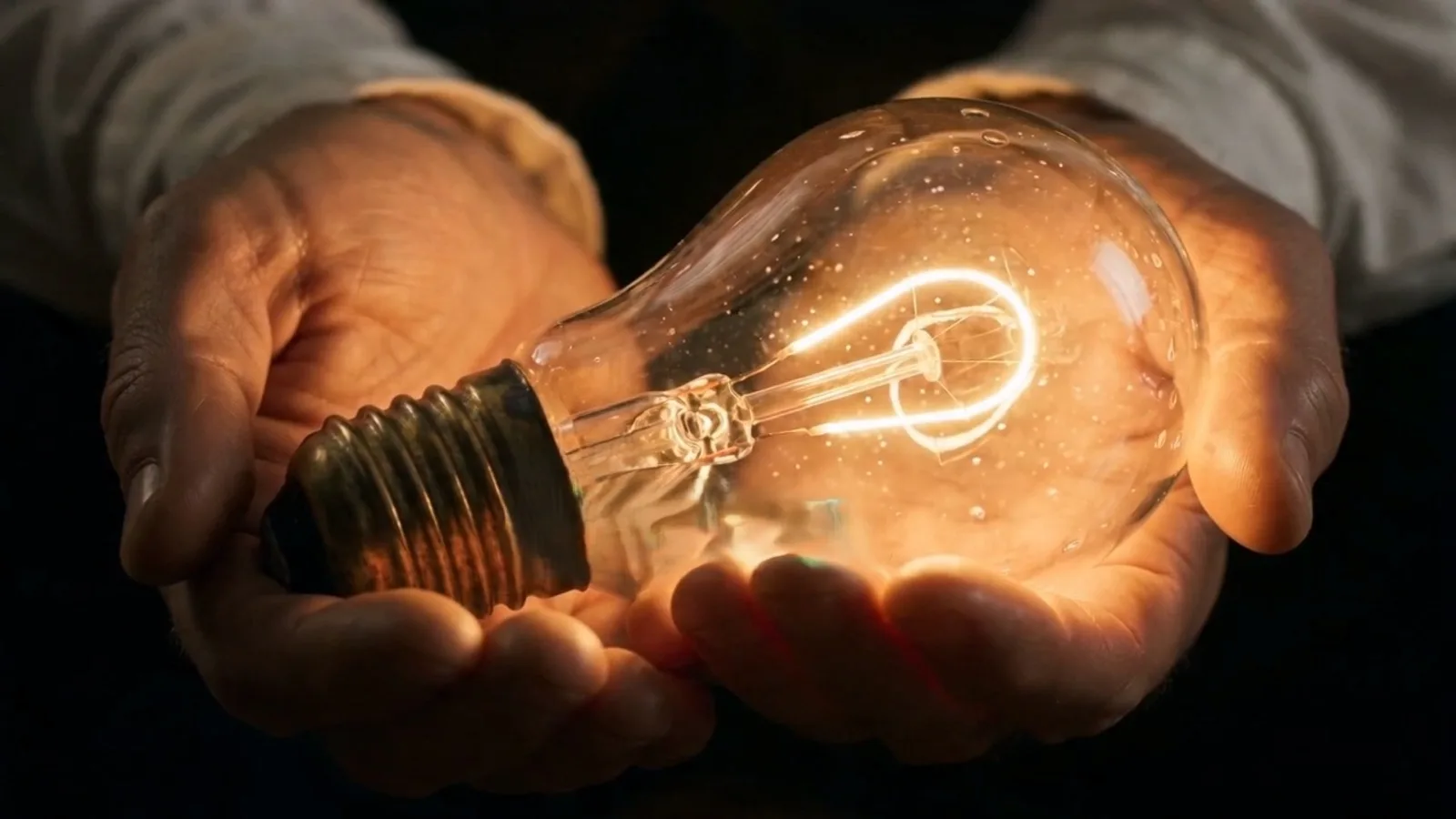 Flova AI video final-cut still: hands cradling a glowing lightbulb